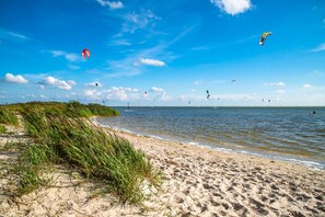 A beach with sand, water, and grass. - Unwind in this modern villa in Friesland (Rijs)