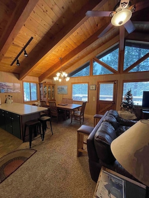 A cozy cabin interior with a dining area, kitchen, and seating space. - Beautiful Lake Tahoe Home at the Northstar Resort! (Truckee)