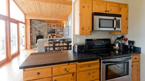 Une cuisine moderne avec des meubles en bois, un four à micro-ondes, un grille-pain et une cuisinière.