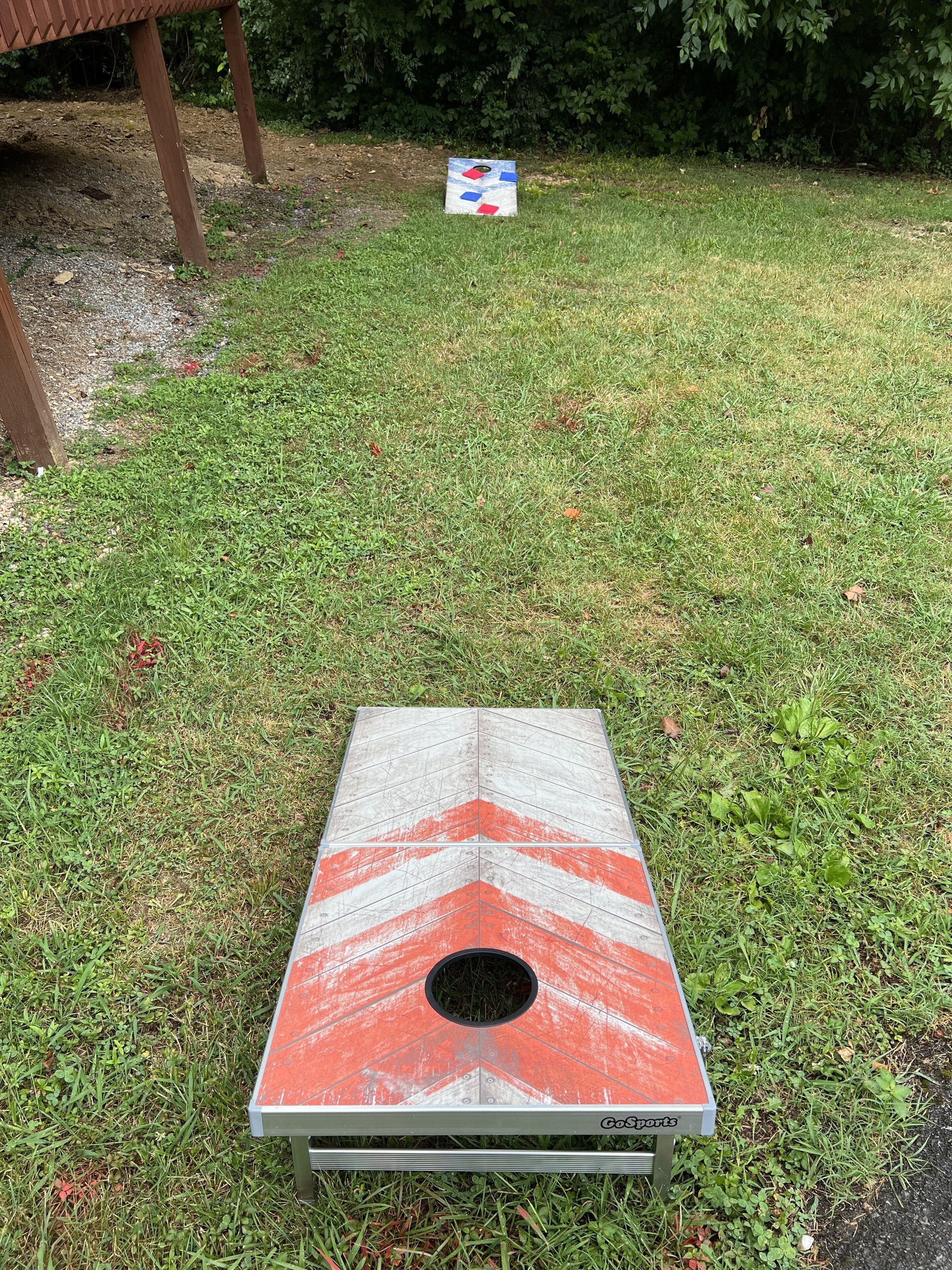 A GoSports portable disc golf basket on a grassy area.