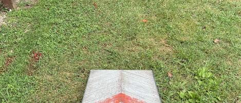 A GoSports portable disc golf basket on a grassy area.