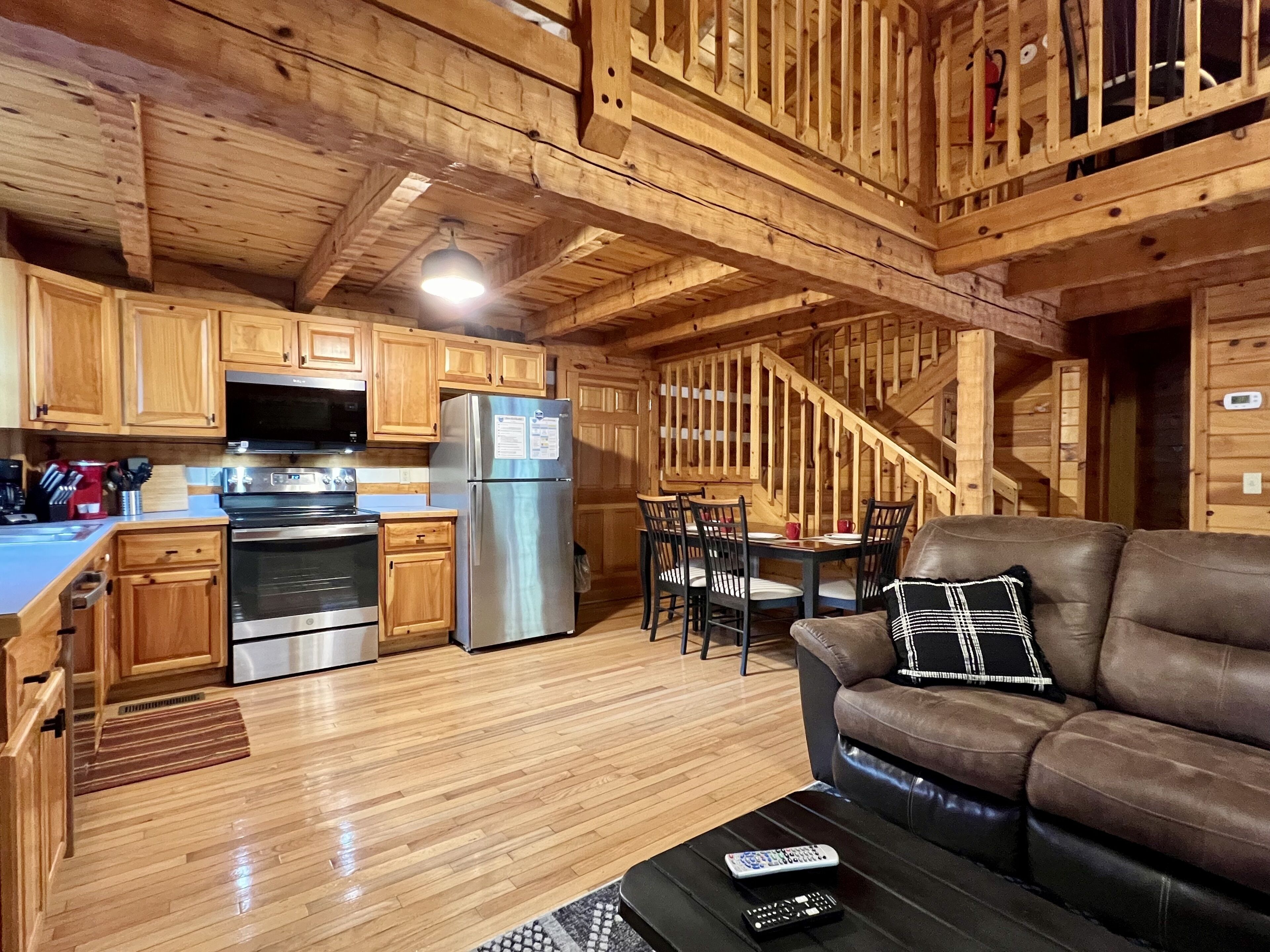 View from fireplace toward sofa, kitchen and dining table