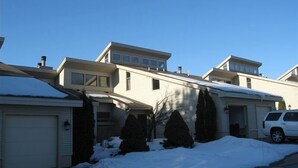 A residential area with houses, a garage, and a driveway.