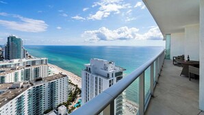 A high-rise building with a balcony overlooking a beach and ocean. - 2 Bedroom Ocean View Escape with Premium Amenities (Hollywood)