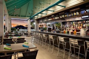 An outdoor bar area with seating and a view of the sunset. - Holiday Inn Club Vacations AT ORANGE LAKE RESORT by IHG (Winter Garden)