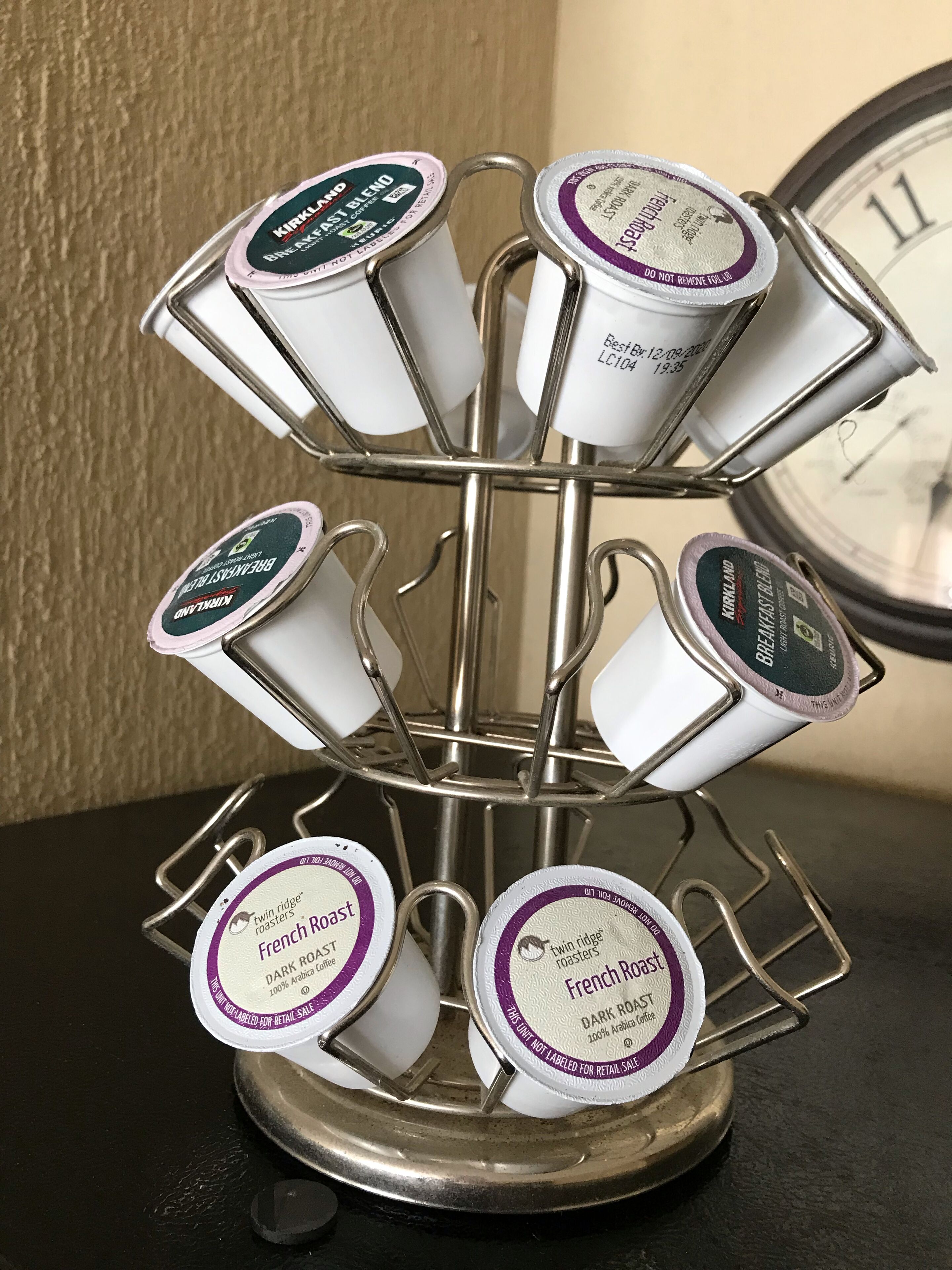 A coffee dispenser with multiple compartments, each labeled with different coffee brands and types.