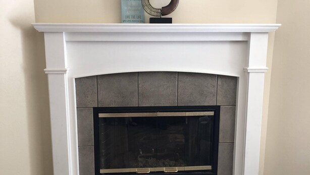 A fireplace with a white mantel, a decorative metal piece, and a motivational quote sign. - PETS welcome! CSU/mid-town Home!  (Fort Collins)