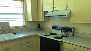 A kitchen with a stove, sink, and cabinets. - PETS welcome! CSU/mid-town Home!  (Fort Collins)