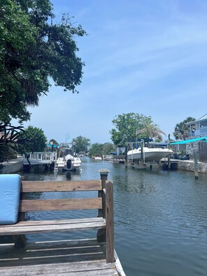 Guests can enjoy serene waterfront views from the dock, surrounded by lush greenery and tranquil waters.