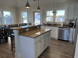 Enjoy cooking in this well-equipped kitchen with a central island, ample counter space, and integrated appliances.