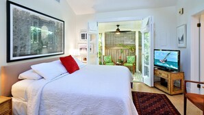 Un dormitorio con cama, televisión y vistas al exterior.