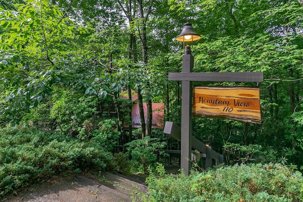 A wooden signpost with a lamp post, surrounded by dense green foliage. - Mountain View | 4 BD Pet-Friendly Montreat Home | Game Room (Montreat)