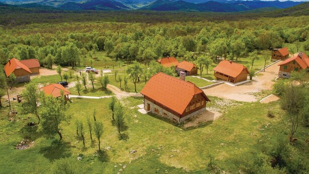 A rural village with traditional wooden houses, surrounded by lush greenery and mountains in the background. - Pet friendly home in Perusic (Perusic)