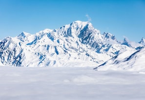 A snow-covered mountain range with a clear sky.