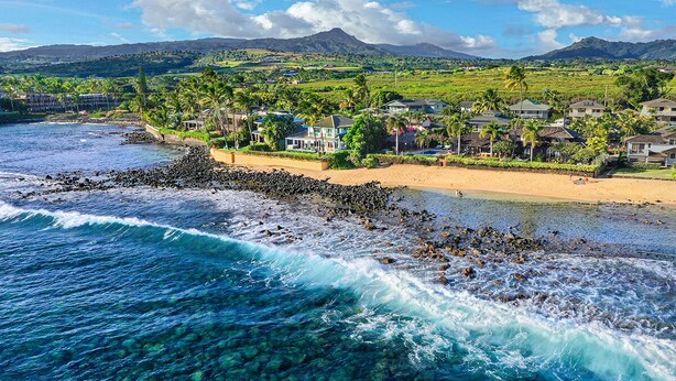 A coastal resort with clear waters, a rocky beach, and houses with a view of the ocean. - Hale Nalu - Beachfront Home Steps from Baby Beach with Spa/AC! (Koloa)