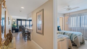A spacious room with a large bed, a ceiling fan, and a view of the outdoors through a window. - Beautiful, updated, oceanfront views!  Gorgeous unit! (Marco Island)