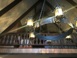 A chandelier with multiple lights and a decorative metal frame.