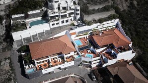 An aerial view of a coastal property with multiple buildings, including a large house with a swimming pool and a smaller structure with a red-tiled roof. - Private sun terraces with ocean/volcano views [I] (Icod de los Vinos)
