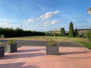 Stroll through this serene outdoor space surrounded by lush greenery and rolling hills.