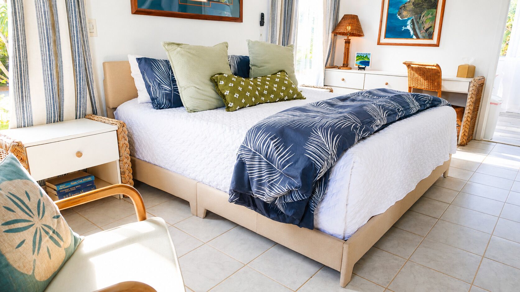 A bedroom with a bed, bedside tables, a chair, and a nightstand.