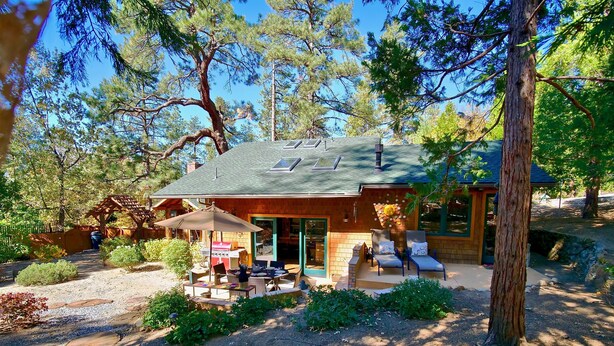A cabin with a patio area, outdoor seating, and a covered barbecue station. - Peaceful Pines "  Lovely Pet Friendly Mountain Home w/ Spa (Idyllwild)