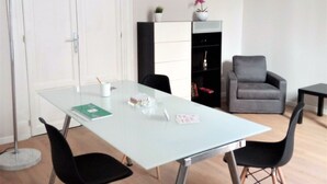 A modern living room with a white sofa, a grey armchair, a glass coffee table, and a floor lamp. - Le vie del Centro (Palermo)