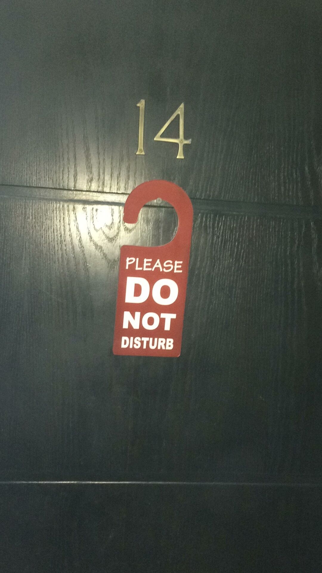 A door with a number 14 and a red sign that says "PLEASE DO NOT DISTURB".
