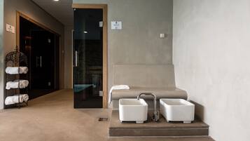 Bathroom features a large sink, a smaller sink, and a towel rack with neatly folded towels.