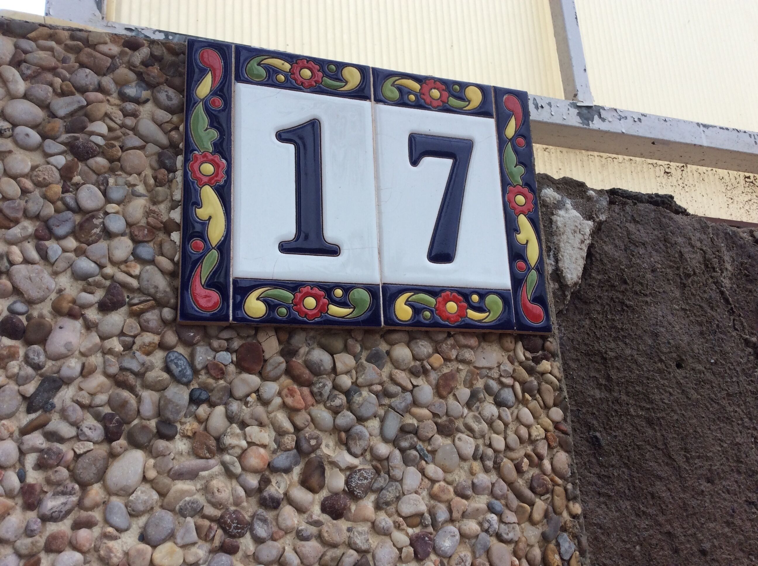 A house number sign with decorative elements.