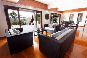 Relax in this stylish living area with a sofa, dining table, and patio views.