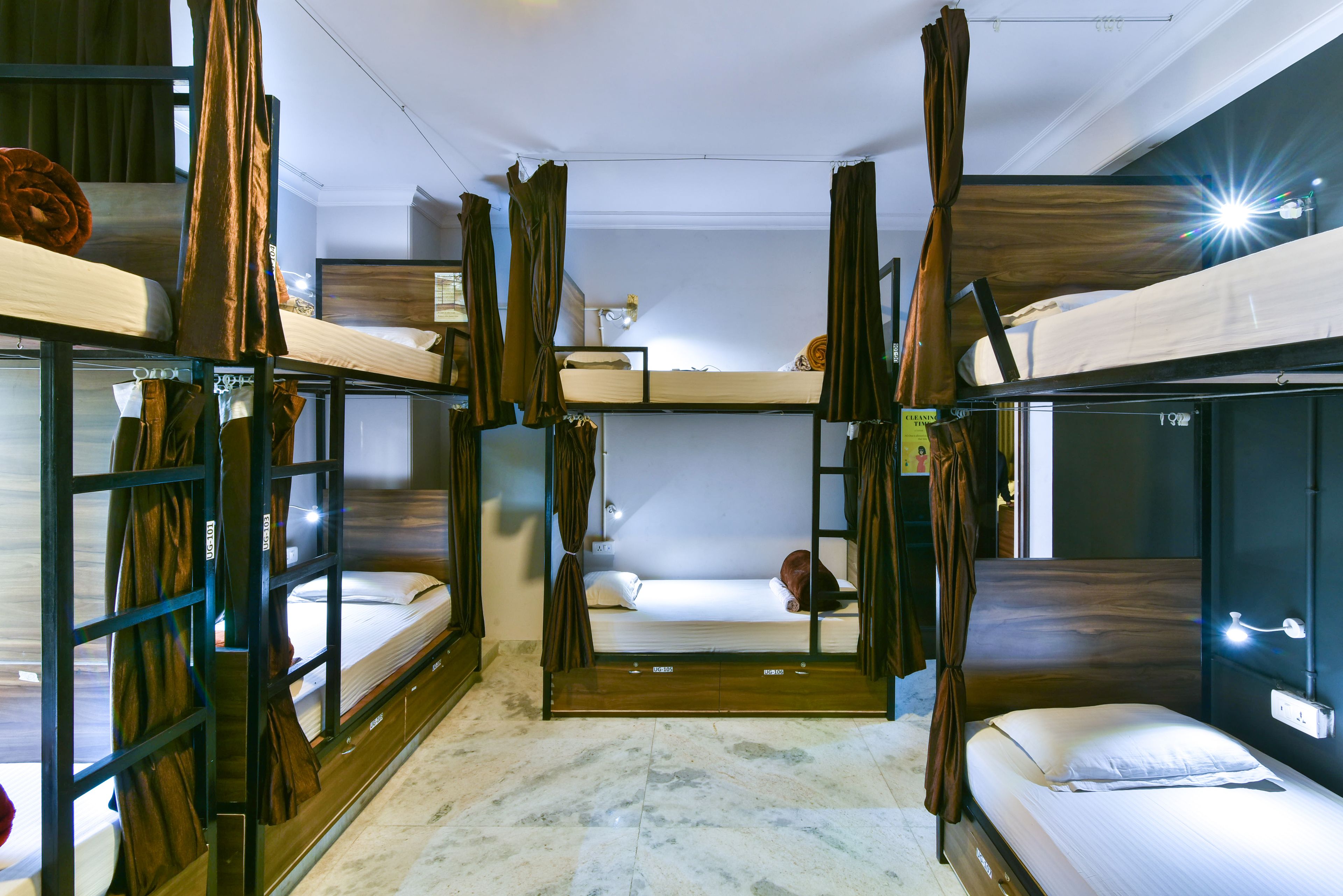 A room with bunk beds, a small table, and a lamp.