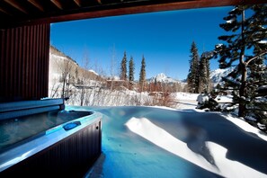 A hot tub with a view of snow-covered mountains and trees. - Luxury Ski In/Out townhome on Creek - Views - Private Hot Tub (Durango)