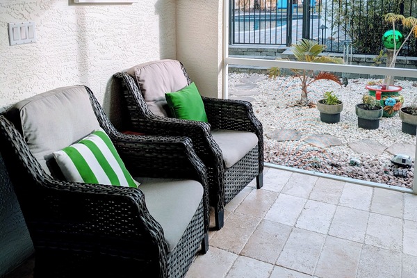 Relax in the breezeway. (the pool is the neighbor's)