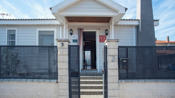A building with a gated entrance, a sign indicating 'Casa Micher', and a 'VT' sign above the door. - Casa Melchor for 9 people (Castejón)