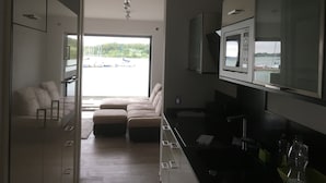 Una cocina moderna con un ventanal grande, un sofá y un televisor.