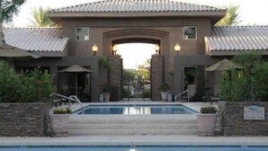 A building with a pool in front, stone walls, and a sign that says "Cottage Inn." - Upscale stay 2.5 blocks to Kierland and Scottsdale Commons shopping.   (Scottsdale)