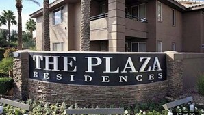 A sign for 'The Plaza Residences' with a modern building in the background. - Upscale stay 2.5 blocks to Kierland and Scottsdale Commons shopping.   (Scottsdale)