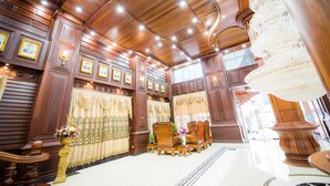 A luxurious room with wooden paneling, chandeliers, and ornate furniture. - Soubandith Hotel (Pakse)