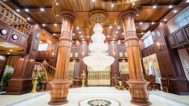 A grand lobby with high wooden ceilings, large chandeliers, and ornate columns. - Soubandith Hotel (Pakse)