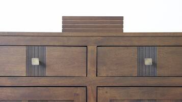 A wooden cabinet with multiple drawers and a flat top surface.
