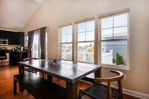 Enjoy cooking in the well-equipped kitchen with a stainless steel range hood, microwave, oven, and coffee maker.