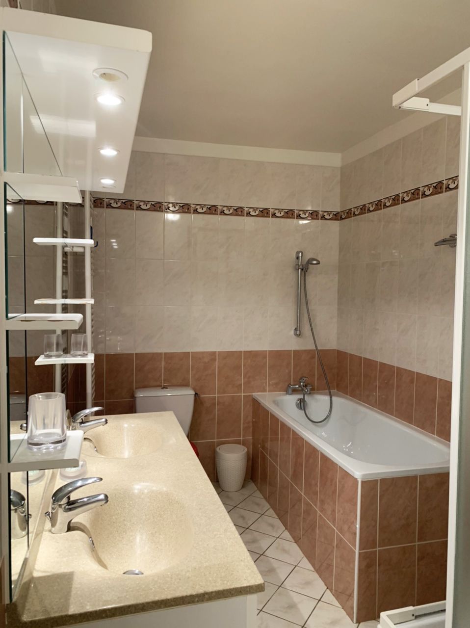 A modern bathroom with a large sink, a bathtub, and a shower.