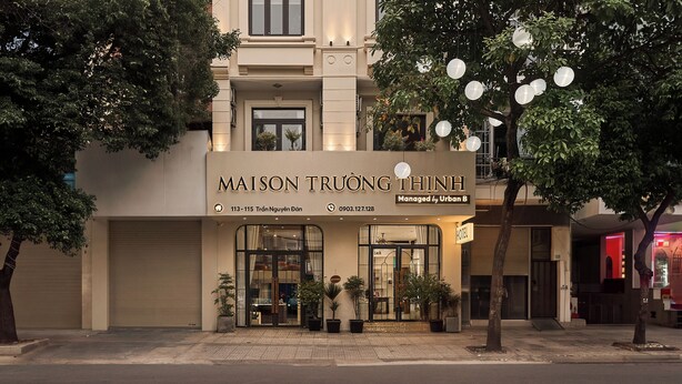 A hotel facade with a sign reading 'MAISON TRUONG THINH' and a contact number. - Maison Truong Thinh Hotel by Urban B (Ho Chi Minh City)