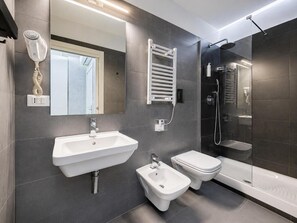 A modern bathroom with a sink, bidet, and shower. - Le Vie del Vaticano (Rome)
