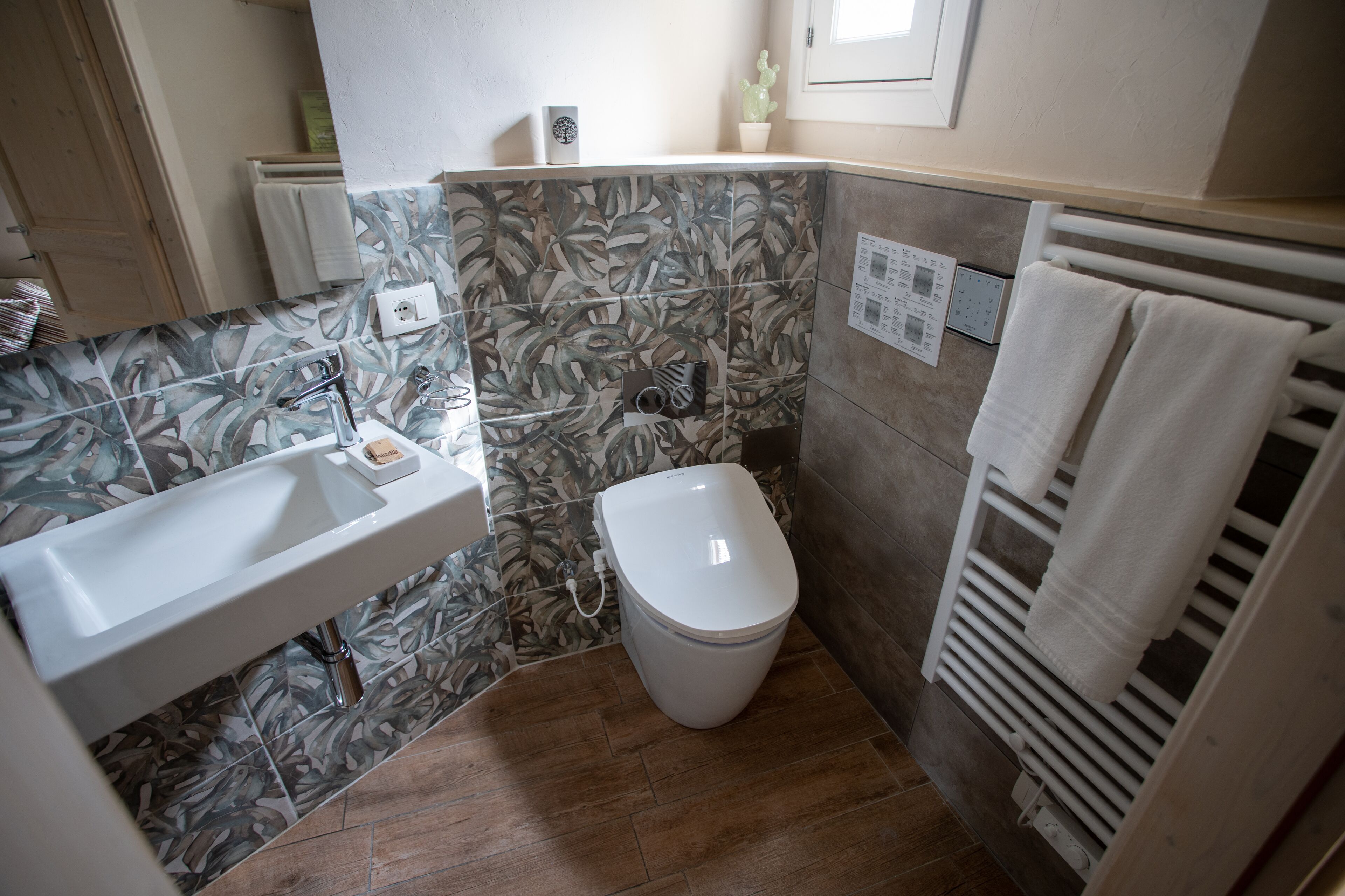 A bathroom with a white sink, toilet, and towel rack.