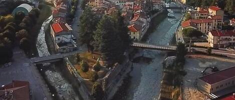 An aerial view of a town with a river, bridges, and buildings.