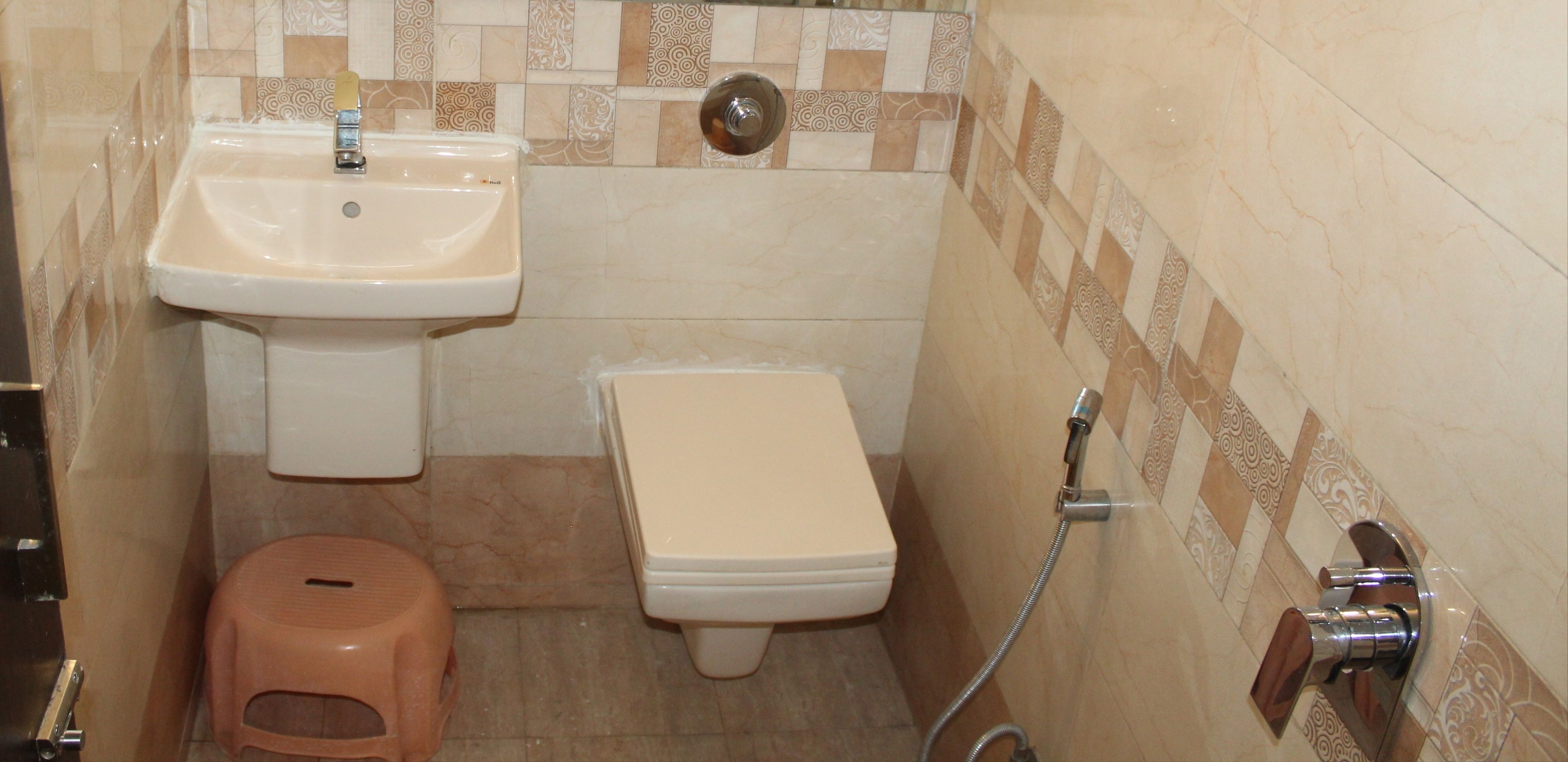 A small bathroom with a sink, toilet, and shower.