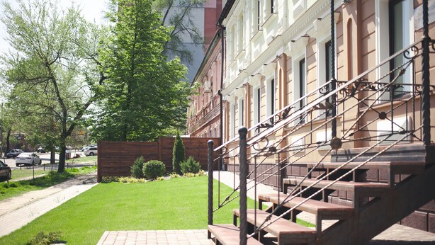 A building with a brick facade and a staircase leading to an upper level. - Ekaterinoslav (Dnipro)