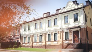 A multi-story building with a classic architectural style, featuring a prominent entrance with steps and a staircase leading to the main door. - Ekaterinoslav (Dnipro)