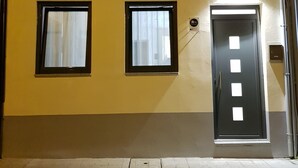 A building with two windows and a door, each with a small square window above. - Apartamento À Francos Metro 1 (Porto)
